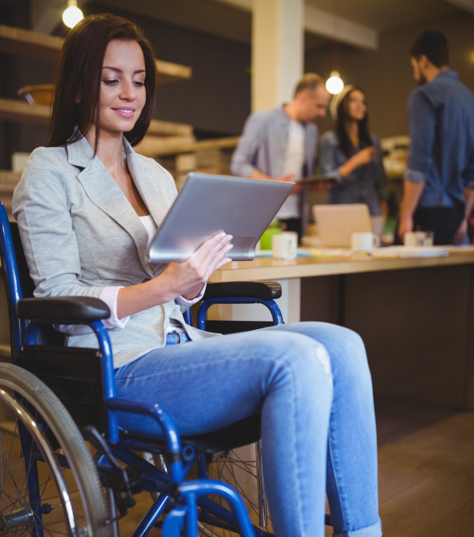 A person sitting on a wheelchair with a computer